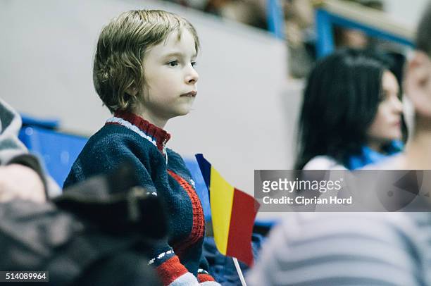 Girl watches a tennis match during day 1 of the Davis Cup World Group first round tie between Romania and Slovenia, on March 4, 2016 in Arad, Romania.