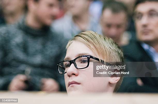 Boy watches a tennis match during day 1 of the Davis Cup World Group first round tie between Romania and Slovenia, on March 4, 2016 in Arad, Romania.