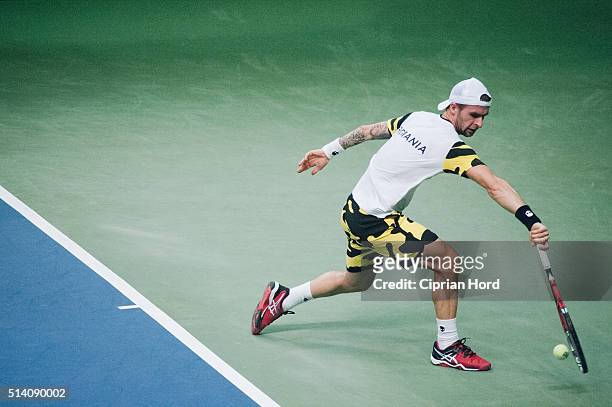 Adrian Ungur of Romania in action against Grega Zemlja of Slovenia during day 1 of the Davis Cup World Group first round tie between Romania and...