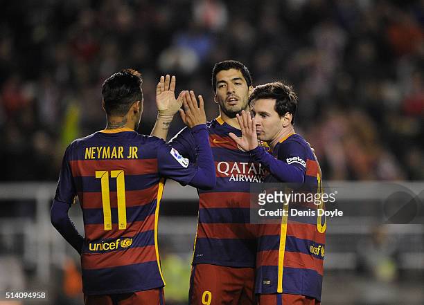 Lionel Messi of FC Barcelona celebrates with Neymar and Luis Suarez after scoring his 2nd goal during the La Liga match between Rayo Vallecano and FC...