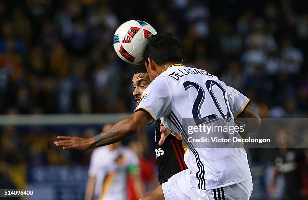 DeLaGarza of Los Angeles Galaxy heads the ball clear from Lamar Neagle of D.C. United in the first half of their MLS match at StubHub Center on March...