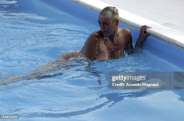 Actress Brigitte Nielsen is seen swimming naked with her fiance Mattia Dessi at a public pool on August 12, 2004 in Milano Marittima, Italy.