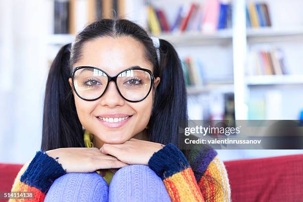 portrait of happy young girl sitting at home - spectacles bunkers stock pictures, royalty-free photos & images