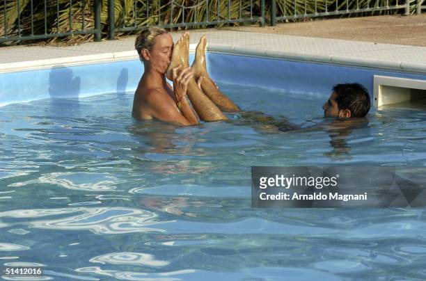 Actress Brigitte Nielsen is seen swimming naked with her fiance Mattia Dessi at a public pool on August 12, 2004 in Milano Marittima, Italy.