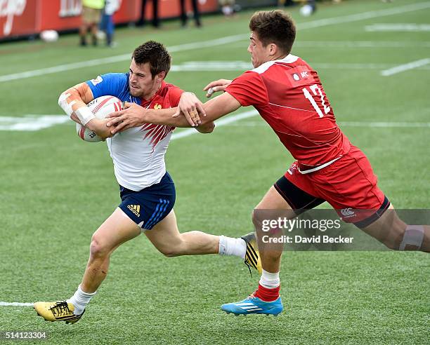 Arthur Retiere of France carries the ball against German Davydov of Russia during the USA Sevens Rugby tournament at Sam Boyd Stadium on March 6,...