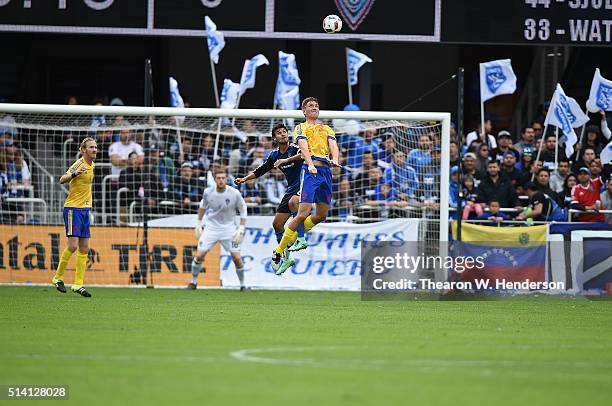 Axel Sjoberg of Colorado Rapids hits a header in front of Chris Wondolowski of San Jose Earthquakes during the first half of their MLS Soccer game at...