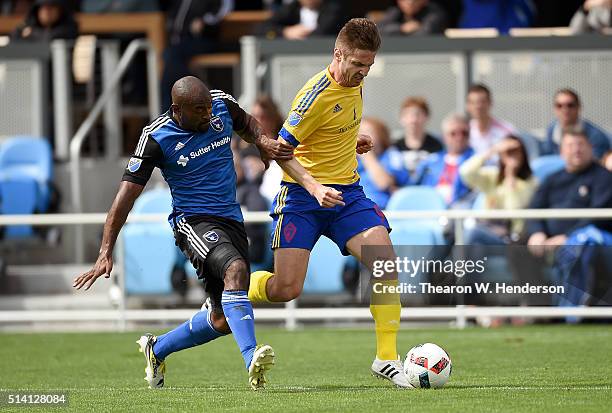 Kevin Doyle of Colorado Rapids fights for control of the ball with Marvell Wynne of San Jose Earthquakes during the first half of their MLS Soccer...