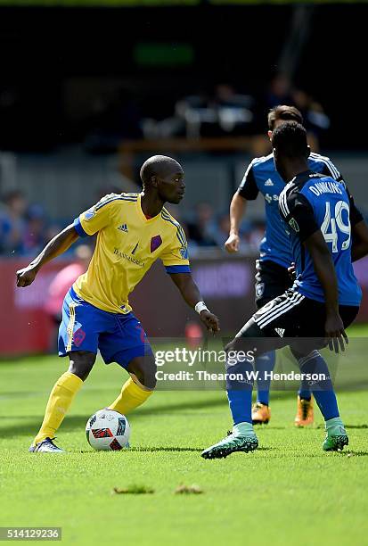 Michael Azira of Colorado Rapids dribbles the ball while guarded by Simon Dawkins of San Jose Earthquakes during their MLS Soccer game in the first...