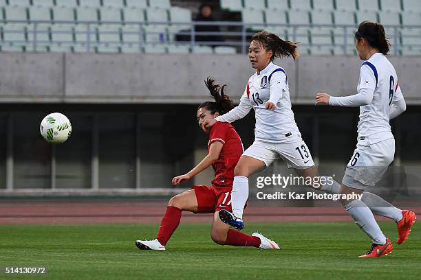 Gu Yasha of China and Jang Selgi of South Korea compete for the ball during the AFC Women's Olympic Final Qualification Round match between China and...