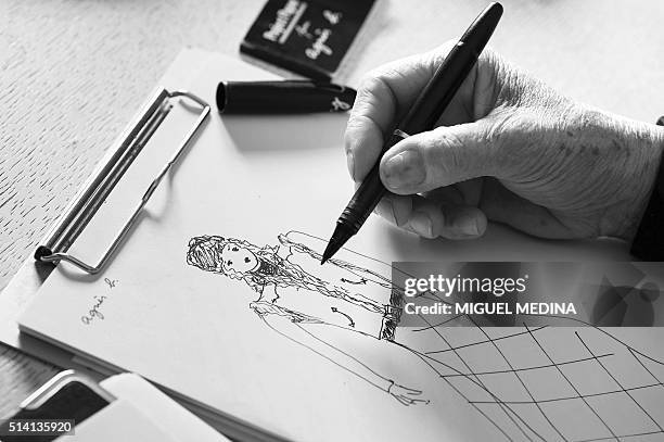 French fashion designer Agnes Trouble known for her fashion brand "agnes b" draws in her studio on February 25 in Paris. / AFP / MIGUEL MEDINA