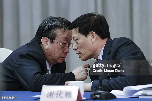 Guo Gengmao, Secretary of the Henan Committee talk with Xie Fuzhan, governor of Henan Province during the Henan delegation's group meeting during the...