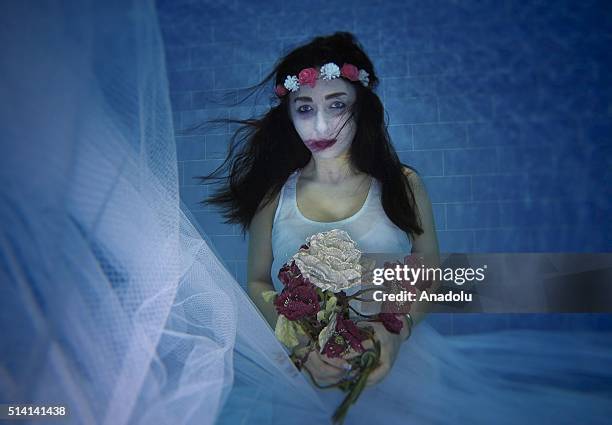 Model performs underwater protest, acting as a woman who exposed to violence, to point out violence to women within a project called "Together...