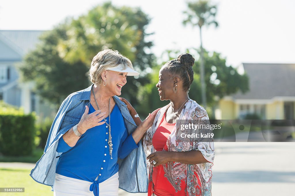 Senior women taking a walk on a sunny day, talking