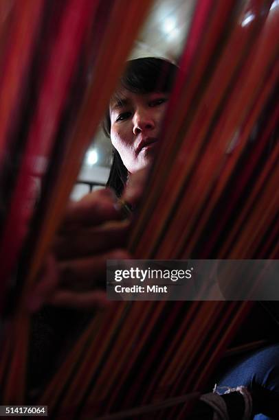 Karma Sonam with a weaver working on handloom at the directorate of Handicraft and Handloom office on March 11, 2015 in Gangtok, India. Karma Sonam...