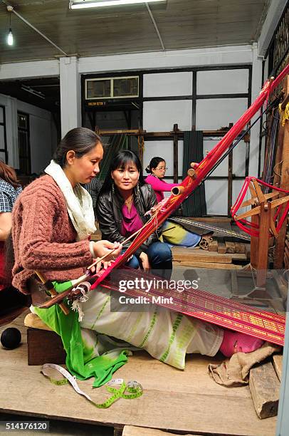 Karma Sonam with a weaver working on handloom at the directorate of Handicraft and Handloom office on March 11, 2015 in Gangtok, India. Karma Sonam...