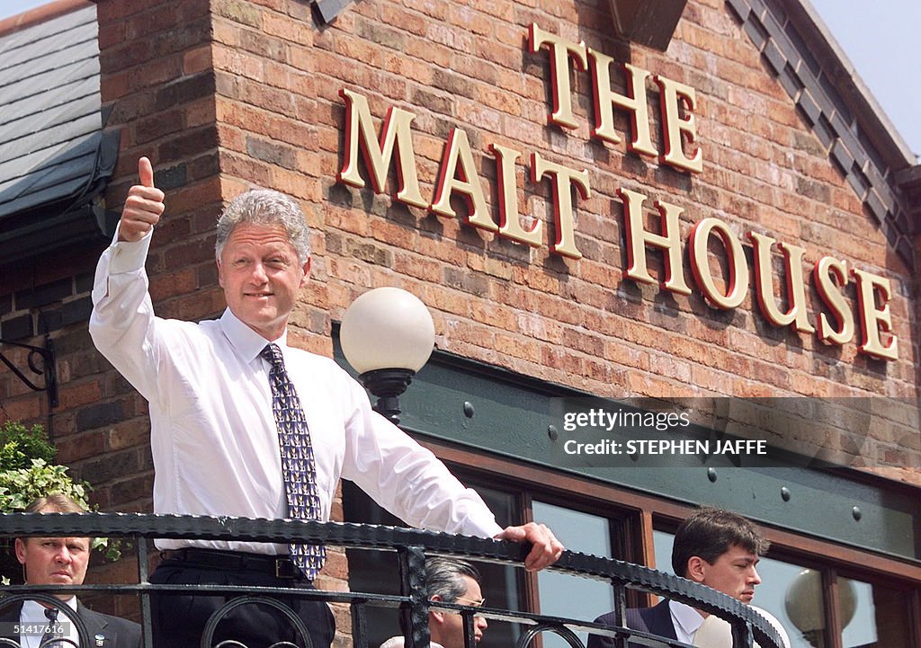 US President Bill Clinton flashes a V thumb-up as