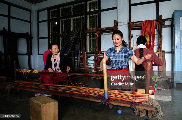 Karma Sonam with a weaver working on handloom at the directorate of Handicraft and Handloom office on March 11, 2015 in Gangtok, India. Karma Sonam...