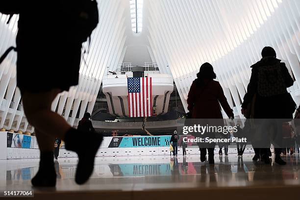 Commuters walk through the Oculus of the partially opened World Trade Center Transportation Hub after nearly 12 years of construction on March 7,...