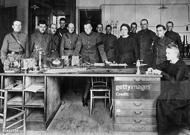 Picture dated 1919 shows Professor Marie Curie working in the laboratory of Paris university, surrounded by her students, young physicists, members...