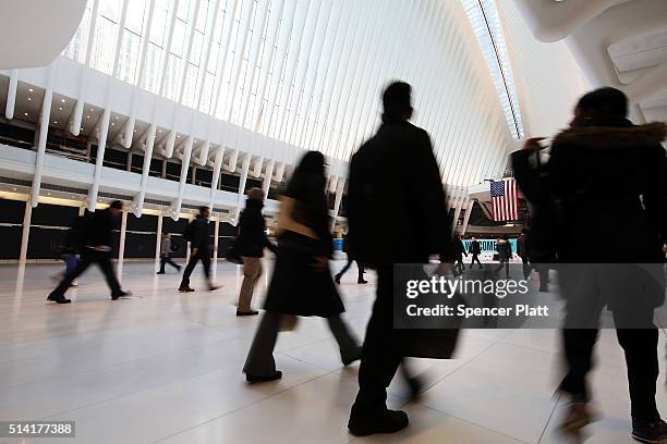 Commuters walk through the Oculus of the partially opened World Trade Center Transportation Hub after nearly 12 years of construction on March 7,...