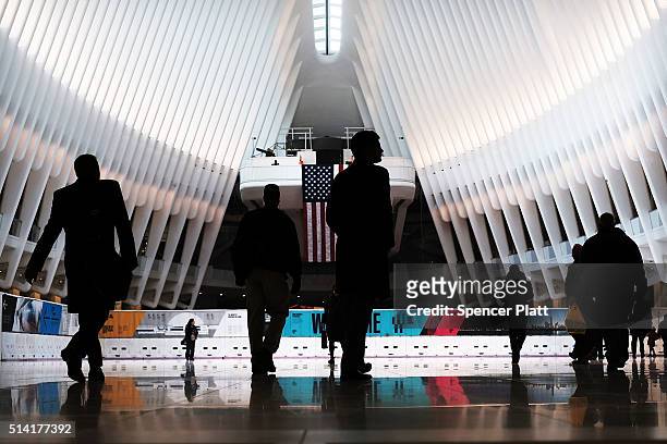 Commuters walk through the Oculus of the partially opened World Trade Center Transportation Hub after nearly 12 years of construction on March 7,...