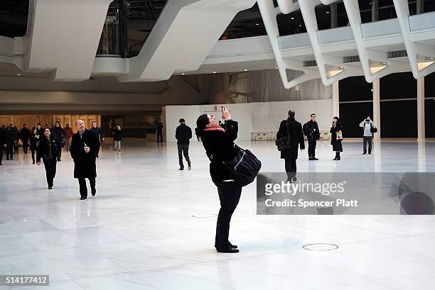 Communter pauses for a picture in the Oculus of the partially opened World Trade Center Transportation Hub after nearly 12 years of construction on...