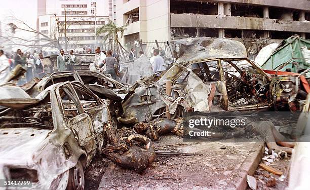 Bodies lay around amid the devastation brought in by a bomb explosion near the US embassy and a bank in Nairobi 07 August that killed at least 60...