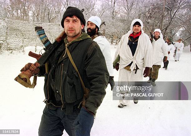 Chechen fighters return to the outskirts of Grozny after their overnight battle against Russian troops in central Grozny, 22 January. Russian forces...