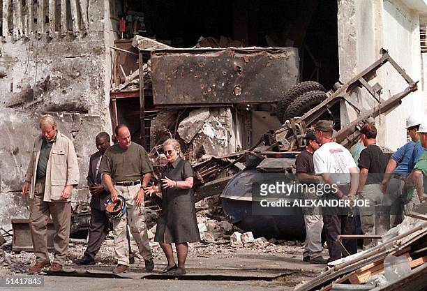 Secretary of State Madeleine Albright talks with a member of the FBI at the US embassy in Dar es Salaam where a bomb exploded 11 days ago, leaving...