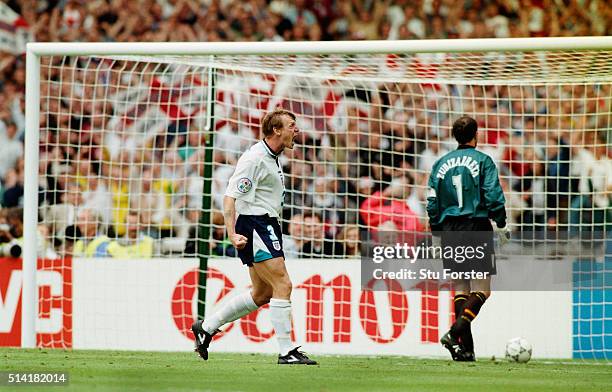 England player Stuart Pearce celebrates after scoring his shoot out penalty past Spain goalkeeper Andoni Zubizarreta during the 1996 European...