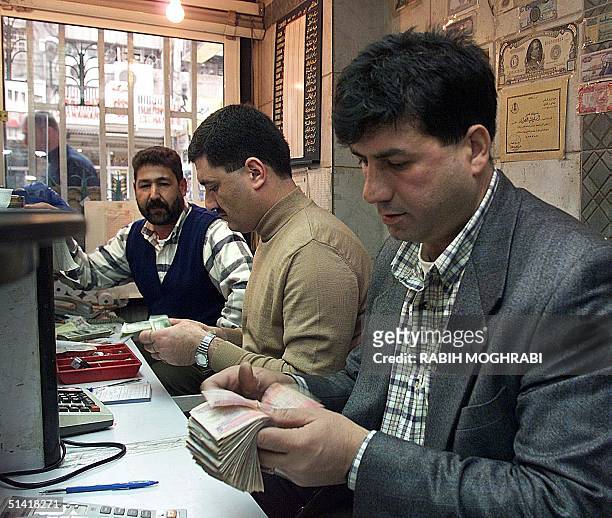 Bank employee counts money 07 February in Amman, where the Jordanian dinar has plunged since King Hussein's return from the US last week following...