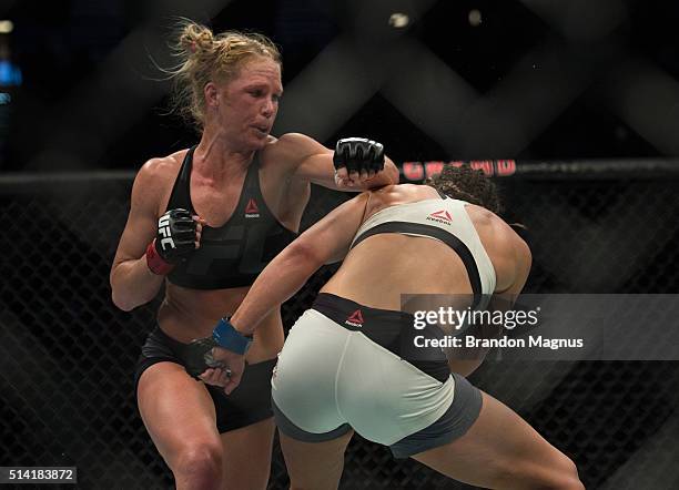 Holly Holm punches Miesha Tate during their women's bantamweight championship bout during the UFC 196 in the MGM Grand Garden Arena on March 5, 2016...
