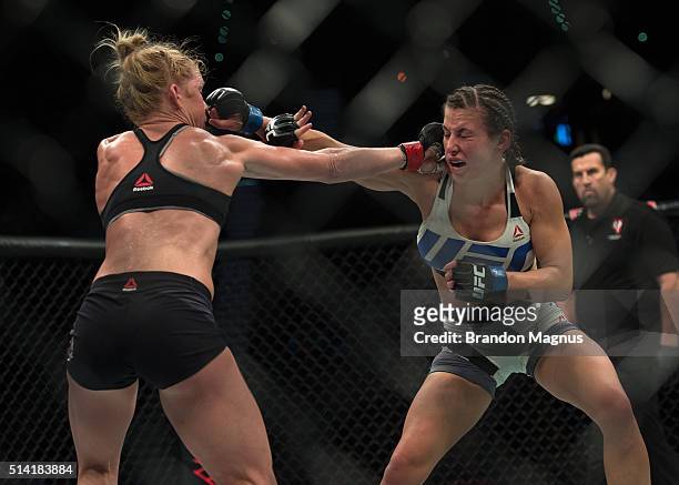 Holly Holm exchanges punches with Miesha Tate during their women's bantamweight championship bout during the UFC 196 in the MGM Grand Garden Arena on...