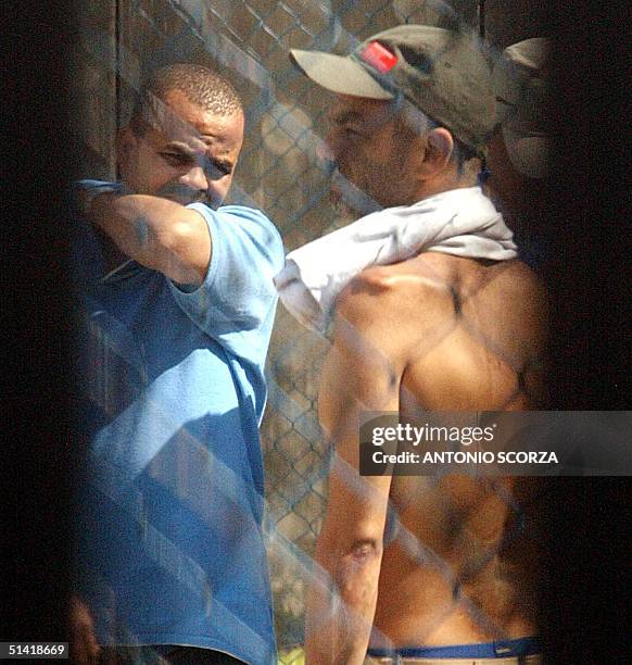 The Drug Dealer Beira Mar is seen speaking with another prisoner through a breach of a fence of the Bangu 1 maximum security prison, 12 September...