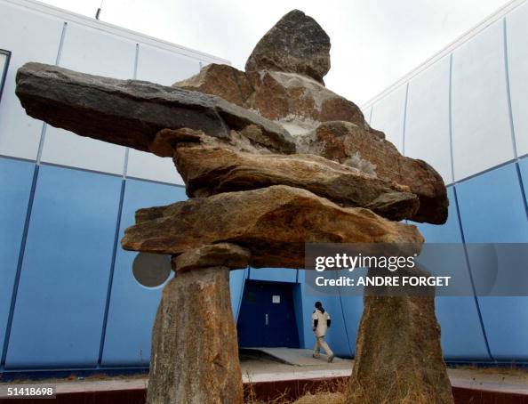 A student enters Inuksuk High School past a Inuksu A student enters Inuksuk High School past a Inuksu