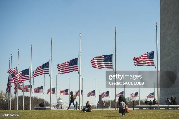 American flags fly at half-staff around the base of the Washington Monument,on the Mall near the US Capitol, in Washington, DC, March 7 in honor of...