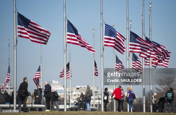 American flags fly at half-staff around the base of the Washington Monument,on the Mall near the US Capitol, in Washington, DC, March 7 in honor of...