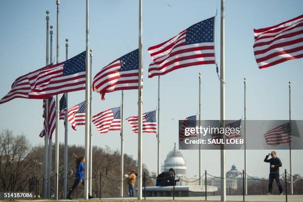 American flags fly at half-staff around the base of the Washington Monument,on the Mall near the US Capitol, in Washington, DC, March 7 in honor of...