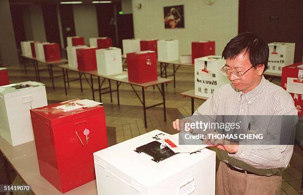 Polling officer shown in photo dated 12 September 1995 putting his final touch to seal a ballot box at a polling training center in Hong Kong.