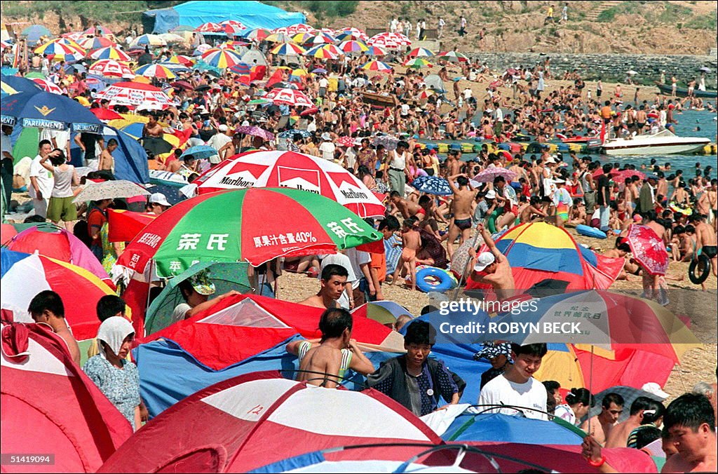 Umbrellas, tents and bodies crowd a popular beach