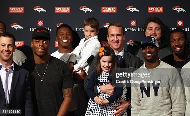 Quarterback Peyton Manning poses with his daughter Mosley, his son Marshall, and former Denver Broncos teammates including Brandon Stokley, Brandon...