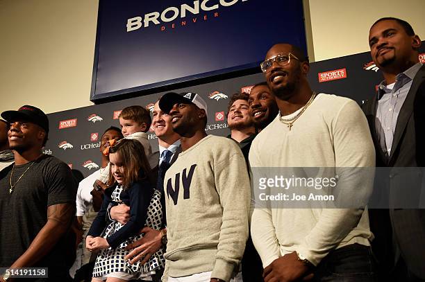 Denver Broncos quarterback Peyton Manning's 4 year old twins Mosley and Marshall join the group for a picture of former and present players after a...