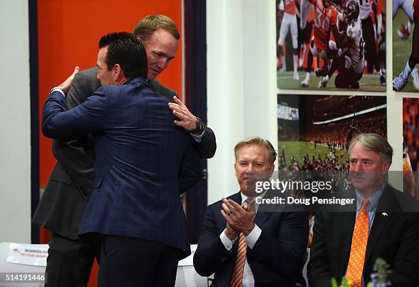 Quarterback Peyton Manning hugs Denver Broncos Head Coach Gary Kubiak prior to announcing his retirement from the NFL at the UCHealth Training Center...
