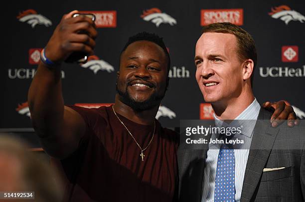 Kenny Anunike takes a selfie with Peyton Manning after his retirement speech. The Denver Broncos hold a press conference to announce the retirement...