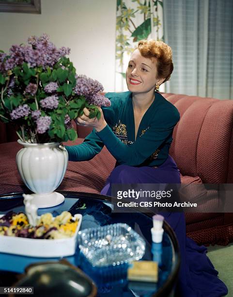 An ardent garden enthusiast, Mary Astor, charming mistress-of-ceremonies of CBS Radios Hollywood Showcase might have grown these spring lilacs to...