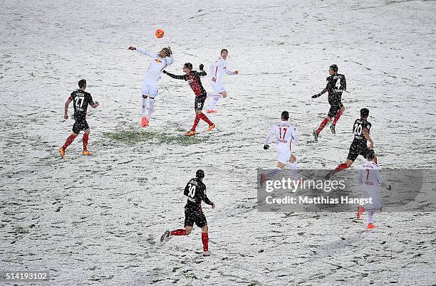 Yussuf Poulsen of RB Leipzig jumps for a header with Pascal Stenzel of Freiburg during the Second Bundesliga match between SC Freiburg and RB Leipzig...