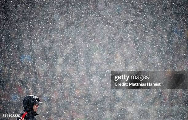 Head coach Ralf Rangnick of RB Leipzig stands in the snow storm during the Second Bundesliga match between SC Freiburg and RB Leipzig at...