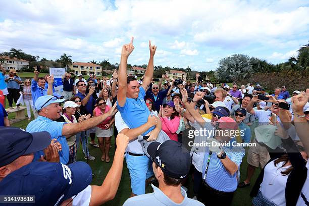 Rickie Fowler of the United States is held aloft by Ernie Els after he had just holed in one in the $1 million Hole-In-One Challenge sponsored by SAP...
