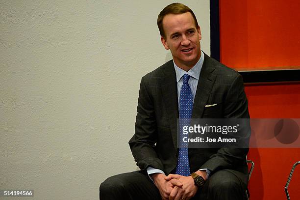 Denver Broncos quarterback Peyton Manning listens to his coach during a press conference to announce his retirement March 7, 2016 at UCHealth...