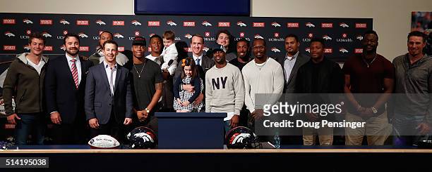 Quarterback Peyton Manning poses with his daughter Mosley, his son Marshall, and former teammates including Brandon Stokley, Brandon Marshall,...